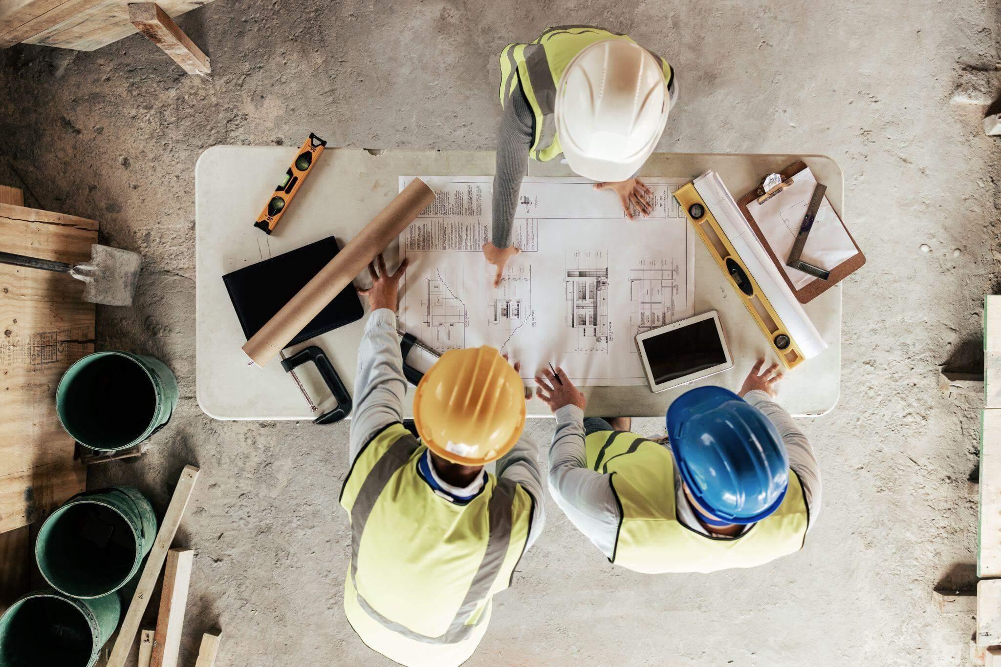 a group of construction workers sitting at a table
